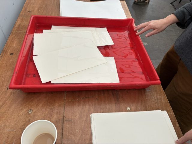 Thick paper soaking in water. Marian Haf print workshop for children at 2026 Eisteddfod